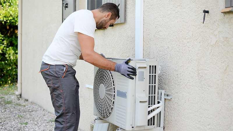 tech installing hvac unit 